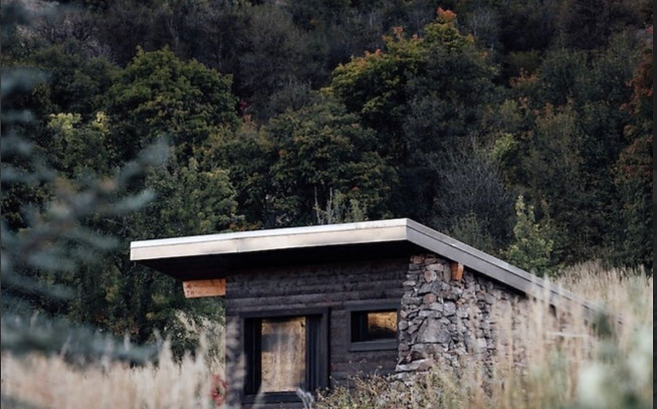 Private stone sauna cabin tucked into the hillside