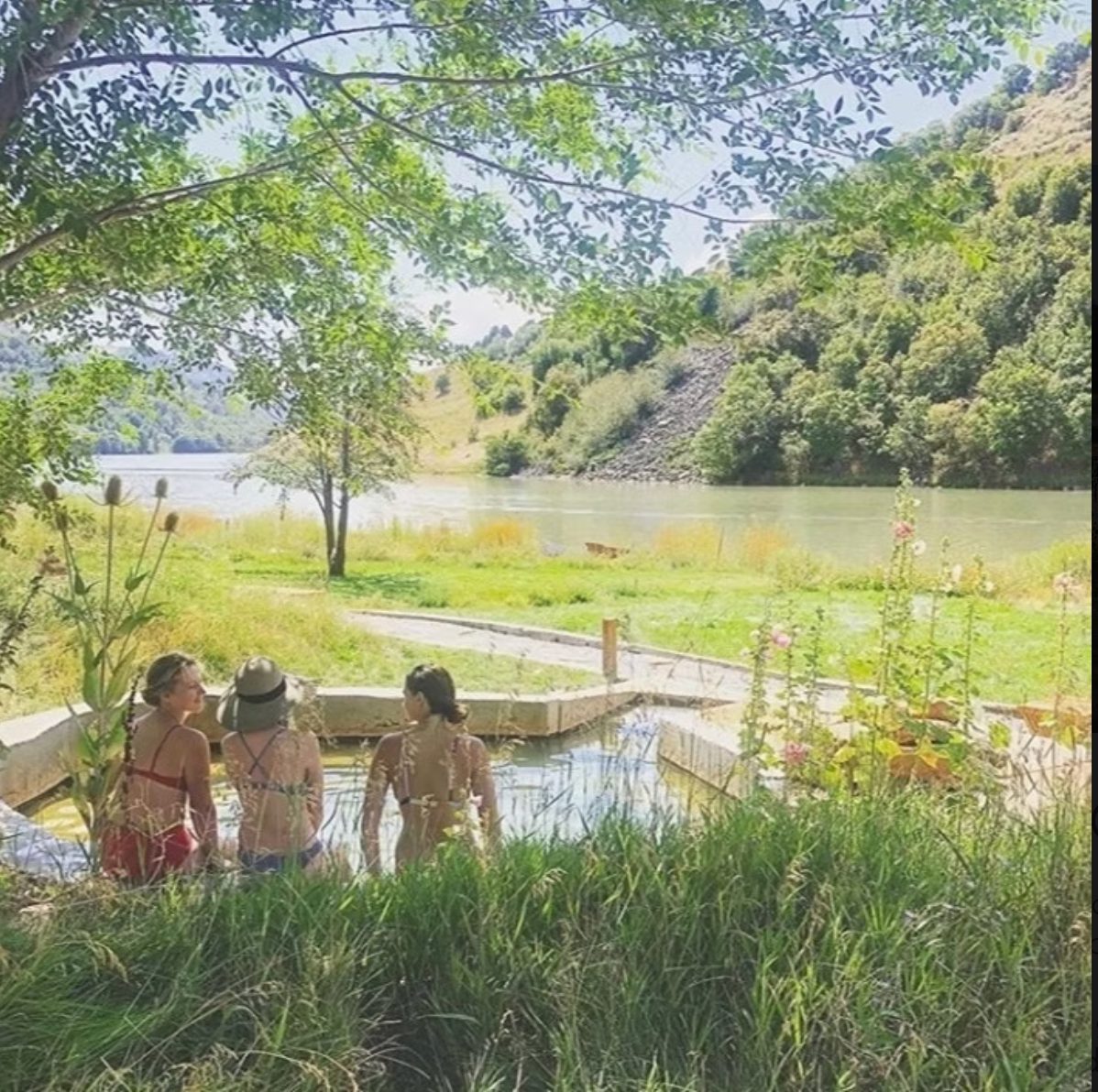 Hot spring pool at dusk with river view